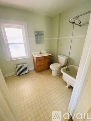 Glens Falls apartment for rent - A bathroom with a toilet, sink, and bathtub.