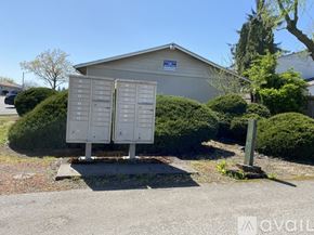 Salem apartment for rent - Two mailboxes stand in front of a building with a blue sign.