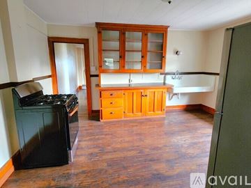 Buffalo apartment for rent - A kitchen with wooden cabinets and a black stove top oven.