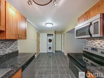 Seattle apartment for rent - A kitchen with a black counter top and a black oven.