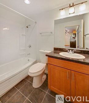 Seattle apartment for rent - A bathroom with a toilet, sink, and bathtub.