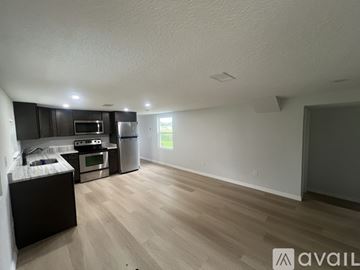 Umatilla house for rent - A kitchen with a refrigerator, microwave, and oven.