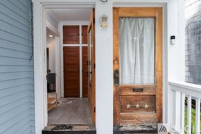 Oneonta apartment for rent - A blue house with a wooden door and a glass window.