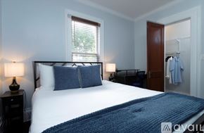 Oneonta apartment for rent - A bedroom with a large bed and a blue blanket.
