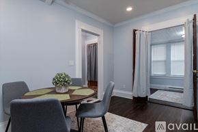 Oneonta apartment for rent - A dining room with a round table and grey chairs.