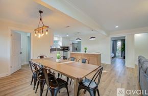 Houston house for rent - A dining room with a long wooden table and chairs.