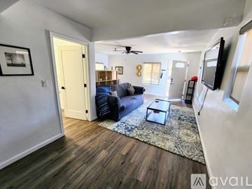 San Diego apartment for rent - A living room with a blue couch and a rug.