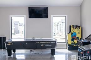 Waynesville apartment for rent - A pool table with a TV above it and a cabinet to the right.