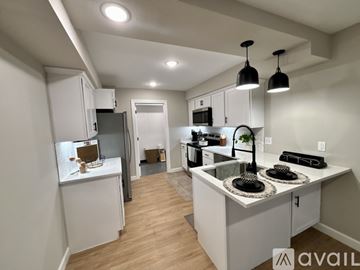 Waynesville apartment for rent - A kitchen with white cabinets and a wooden floor.