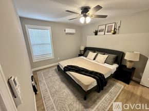 Waynesville apartment for rent - A bedroom with a bed, a ceiling fan, and a rug.