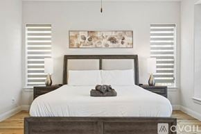 Irving house for rent - A bedroom with a large bed and a painting above it.