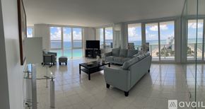 Hollywood condo for rent - A dining room with a table set for six with a view of the ocean.