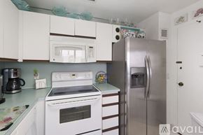 Hollywood condo for rent - A kitchen with a white oven and a stainless steel refrigerator.