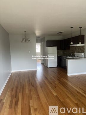 Morton Grove apartment for rent - A kitchen with wooden floors and a white refrigerator.