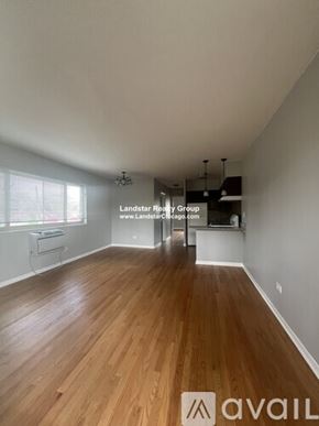 Morton Grove apartment for rent - A room with wooden flooring and a window with blinds.