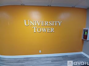 Knoxville condo for rent - A room with wooden flooring and a large window with blue curtains.