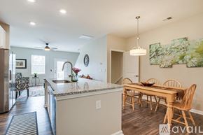 Greenville townhouse for rent - A kitchen with a dining table and chairs.