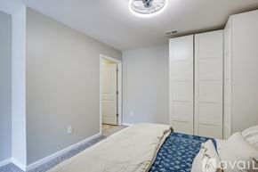 Greenville townhouse for rent - A bedroom with a bed and a ceiling fan.