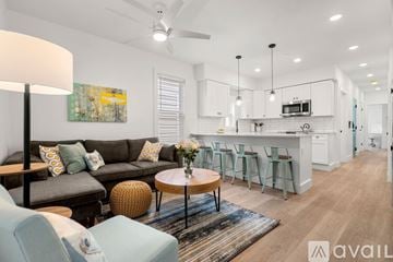 Boston apartment for rent - A modern living room with a grey sofa and a wooden coffee table.