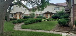 Milwaukee apartment for rent - A row of houses with a lawn in front.