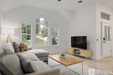 Austin house for rent - A living room with a grey couch and a wooden coffee table.
