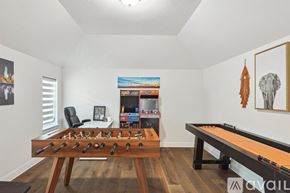 Irving house for rent - A room with a foosball table and a pool table.