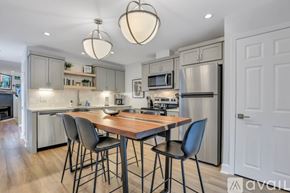Savannah apartment for rent - A kitchen with a table and chairs in front of a refrigerator.