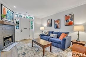 Savannah apartment for rent - A living room with a blue couch, a fireplace, and a rug.