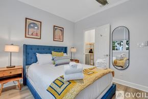 Savannah apartment for rent - A bedroom with a blue headboard and a bed with a yellow and blue comforter.