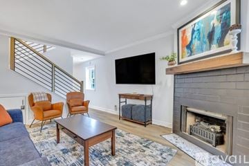 Savannah apartment for rent - A living room with a fireplace and a painting on the wall.