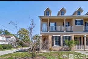 Winter Park townhouse for rent - A two-story house with a balcony and multiple windows.