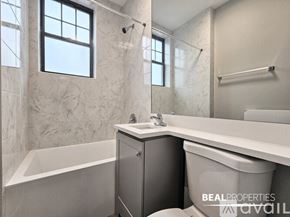 Evanston apartment for rent - A bathroom with a tub, toilet, and sink.