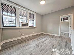 Evanston apartment for rent - A room with a window, a door, and a wall socket.