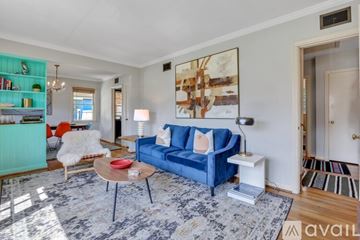 Savannah apartment for rent - A living room with a blue couch and a coffee table.