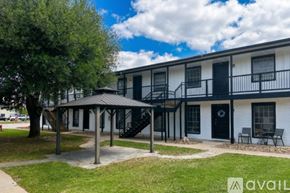 Bryan apartment for rent - A tree in a grassy area in front of apartment buildings.