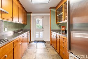 Savannah apartment for rent - A kitchen with wooden cabinets and a green backsplash.