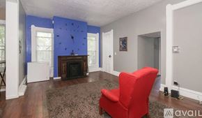 Cleveland house for rent - A red chair is in a room with blue walls.