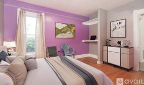 Cleveland house for rent - A bedroom with a bed, a chair, a cabinet, and a painting on the wall.