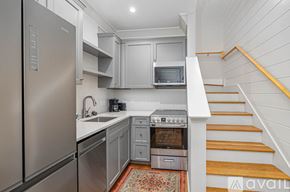 Savannah apartment for rent - A kitchen with a refrigerator, oven, and microwave.