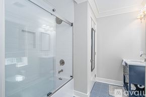 Savannah apartment for rent - A bathroom with a glass shower door and a white wall.