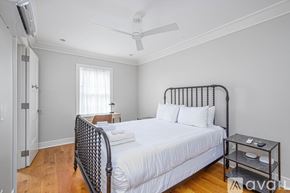 Savannah apartment for rent - A bedroom with a large bed and a ceiling fan.