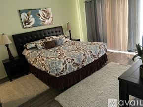 Palm Desert condo for rent - A bedroom with a large bed and a painting above it.