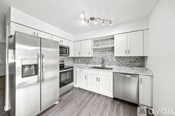 Stow apartment for rent - A kitchen with a refrigerator, microwave, oven, sink and cabinets.