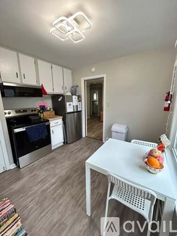 Ypsilanti apartment for rent - A kitchen with yellow walls and white cabinets.