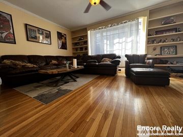 Brookline apartment for rent - A living room with a brown leather couch and a wooden floor.