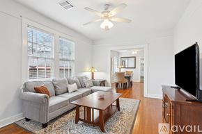 New Orleans apartment for rent - A living room with a grey couch, a wooden coffee table, and a flat screen TV.
