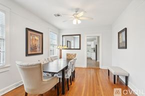New Orleans apartment for rent - A dining room with a wooden table and chairs.
