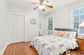 New Orleans apartment for rent - A bedroom with a large bed and a ceiling fan.