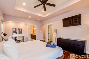 Houston house for rent - A bedroom with a large bed and a ceiling fan.