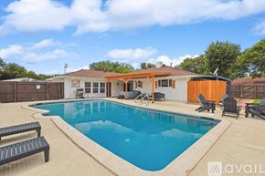 Desoto house for rent - A pool with a bench and a house in the background.